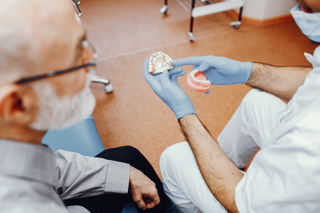 A dentist explaining implant dentures to a patient