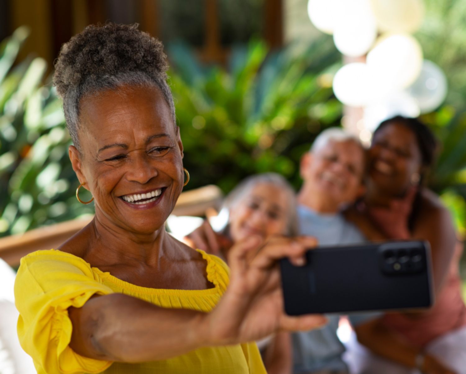 A woman taking a picture of herself and her family