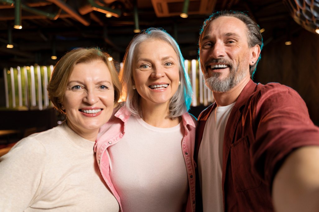 Three people smiling for a picture